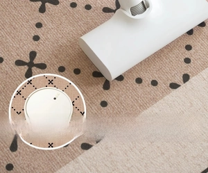 Close-up of a robot vacuum cleaning a vintage geometric patterned rug with ease