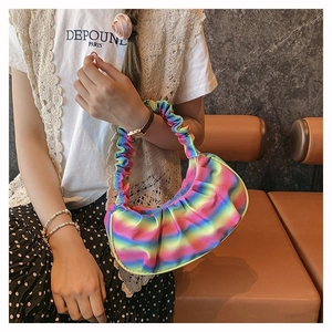 Close-up of rainbow gradient pleated dumpling bag with satin texture finish
