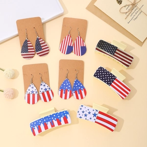 Close-up of American flag themed teardrop earrings and hair clips for Independence Day