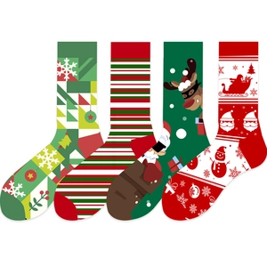 Close-up of four festive Christmas socks with reindeer, snowman and tree patterns