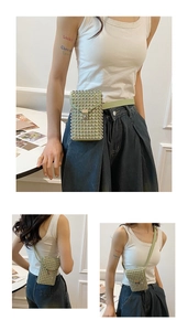 Detailed view of a light green rhinestone crossbody bag with round rivets and metal lock