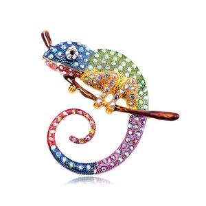 Vintage lizard brooch featuring colorful rhinestones on a golden metal branch base