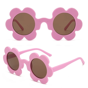 Detail view of pink floral frame sunglasses with round brown lenses for kids