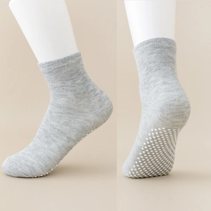 Detailed view of grey baby floor socks with non-slip silicone grippers on the sole