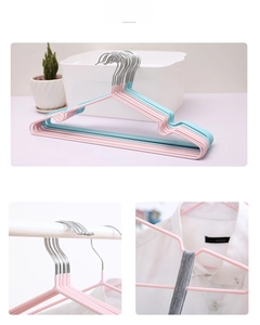 Detail of non-slip PVC coated hangers with shoulder notches and metal hooks in pastel colors