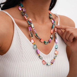 Detail of bohemian double-layered necklace with colorful shell slices and beads
