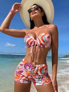 Close-up of vibrant floral graffiti print bikini top with drawstring and boy shorts set