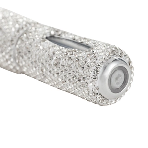 Macro detail of diamond-encrusted perfume atomizer with sparkling rhinestones for travel