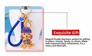 Detail of blue rhinestone poodle keychain with golden metal ring and woven strap