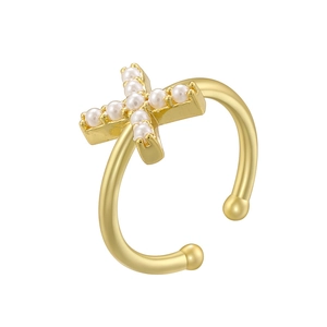 Detail of a gold-plated cross ear cuff featuring elegant white pearls and an open design