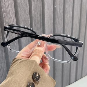 Detail of two-tone TR90 frame with black top and clear bottom stylish square design