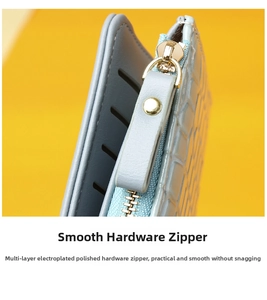 Detailed macro of smooth golden hardware zipper on a light blue embossed long wallet