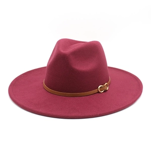Detail of maroon wool fedora with brown leather band and gold metal buckle accent