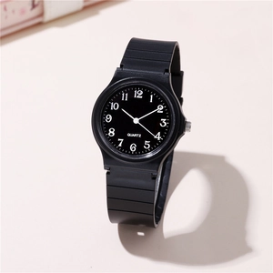Detailed close-up of a minimalist black quartz watch with white numeric scale and resin strap