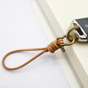 Handmade brown leather keychain with vintage brass horseshoe clasp on car key