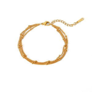 Detailed view of 18k gold plated stainless steel triple-layer beaded bracelet with lobster clasp