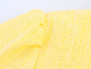 Detailed macro view of yellow linen woven fabric texture on a rural style long dress