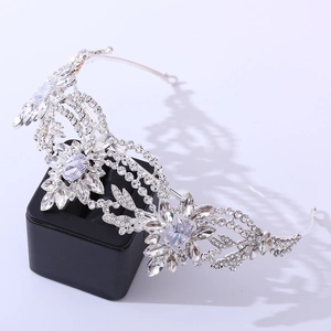 Elegant silver floral bridal crown with zircon crystals on a black display stand