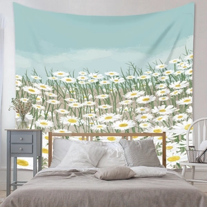 Detail of floral tapestry featuring white daisies on wall above a cozy bedroom bed