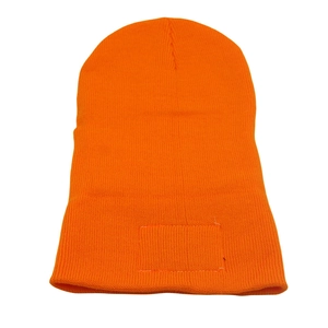 Detailed view of the ribbed knit texture and rectangular patch on orange beanie