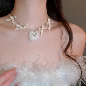 Elegant ribbon bow necklace with plush pom-pom and heart rhinestone pendant detail