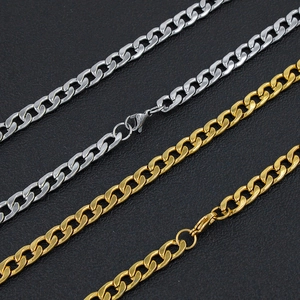 Detailed macro view of gold and silver cuban curb chains with lobster clasps on black texture