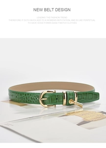 Detailed view of dark green crocodile pattern leather belt with golden metal buckle and lock