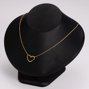 Minimalist golden hollow heart pendant necklace with fine snake chain on black display