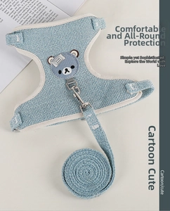 Close-up of light blue pet harness with cute bear patch and breathable mesh fabric