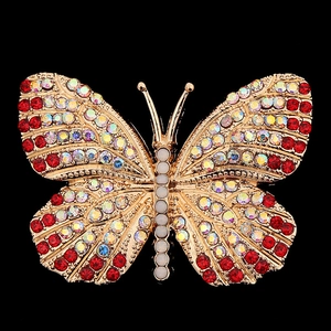 Macro detail of golden butterfly accessory with red and iridescent AB crystals