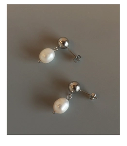 Detailed shot of irregular freshwater pearl drop earrings with polished silver studs