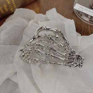 Silver skull hand hair claw clip in metallic gothic style for Halloween accessories
