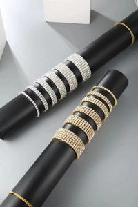 Detail of silver and gold multi-row stretch bracelets with sparkling rhinestones