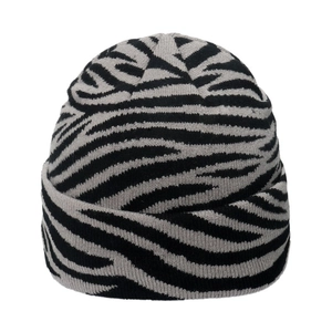 Detail view of the zebra pattern knit beanie showing soft grey and black wool texture