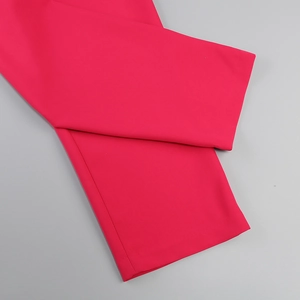 Detailed view of the hem stitching on rose red ostrich feather suit trousers