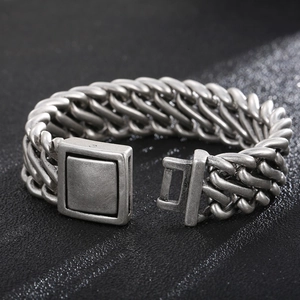 Macro detail of vintage silver steel chain bracelet with industrial square clasp texture