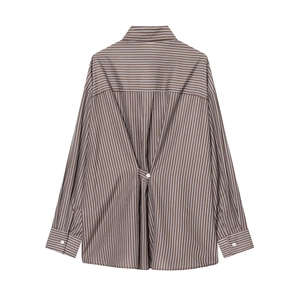 Detail of striped poplin shirt featuring vertical lines and back button adjustment strap