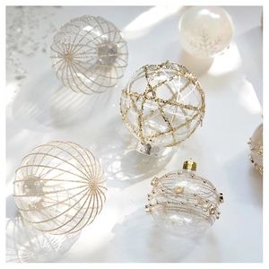 Close-up of champagne swan lace Christmas ornaments with gold and silver glitter stars