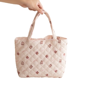 Quilted pink tote bag with cartoon bear pattern and soft texture for daily use