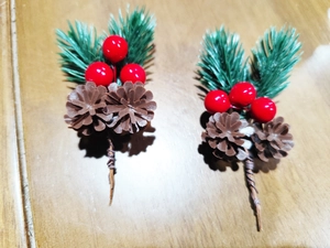 Macro detail of artificial Christmas picks with red berries, pine cones and needles