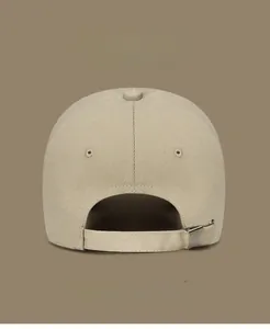 Detail of khaki cotton baseball cap back with adjustable metal buckle and vent holes