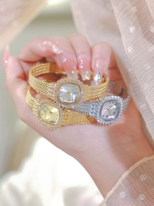 Close-up of square Bee Sister watches with crystal bezel and metal mesh band