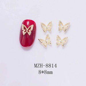 Macro detail of 8x8mm mini golden hollow butterfly metal charms for 3D nail art design