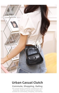 Close-up of a glossy black mini jelly bag with metal chain strap and top handle