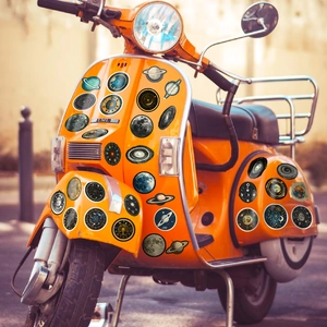 Space-themed astronomy stickers featuring planets and moons on a vintage orange scooter