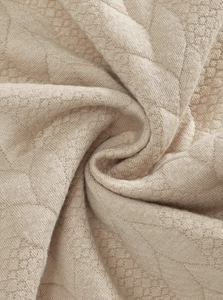 Close-up of khaki knitted fabric with honeycomb texture and soft premium stitching