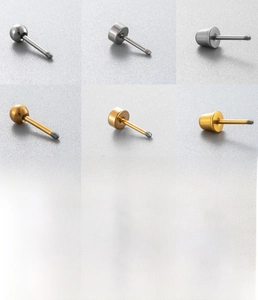 Detailed view of titanium steel earring backings in silver and gold finishes