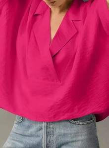 Close-up of rose red short sleeve V-neck shirt showing collar detail and fabric texture