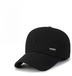 Close-up of thick black wool baseball cap with SPORT metal badge for autumn and winter
