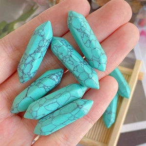 Macro detail of turquoise hexagonal point crystal with natural black mesh texture